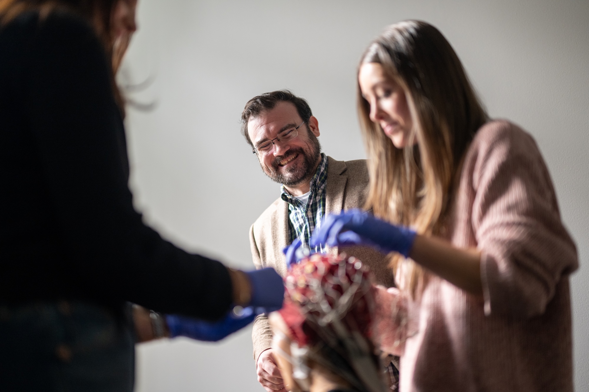 Patrick Cox watches students use an EEG cap to study the brain's reactions